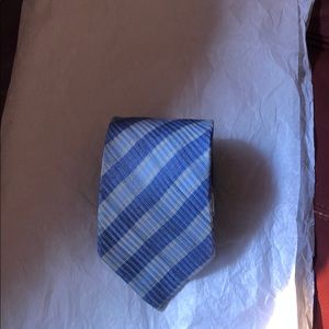 Neck tie in stripes of blue and touch of gold